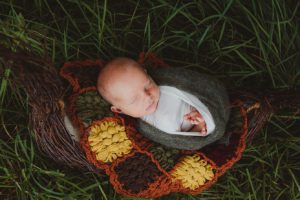 sleepy newborn outside in basket-NicCole Photography