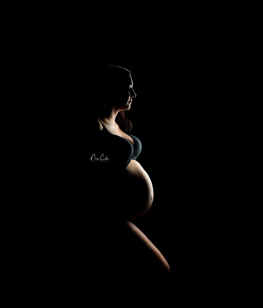 a mothers baby bump backlit -Charlotte photographer