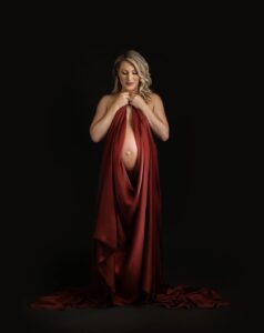pregnant mother dropped in orange cloth for maternity photo
