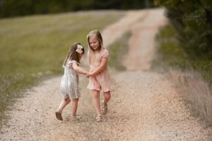 little girls holding hands spinning _niccole photography