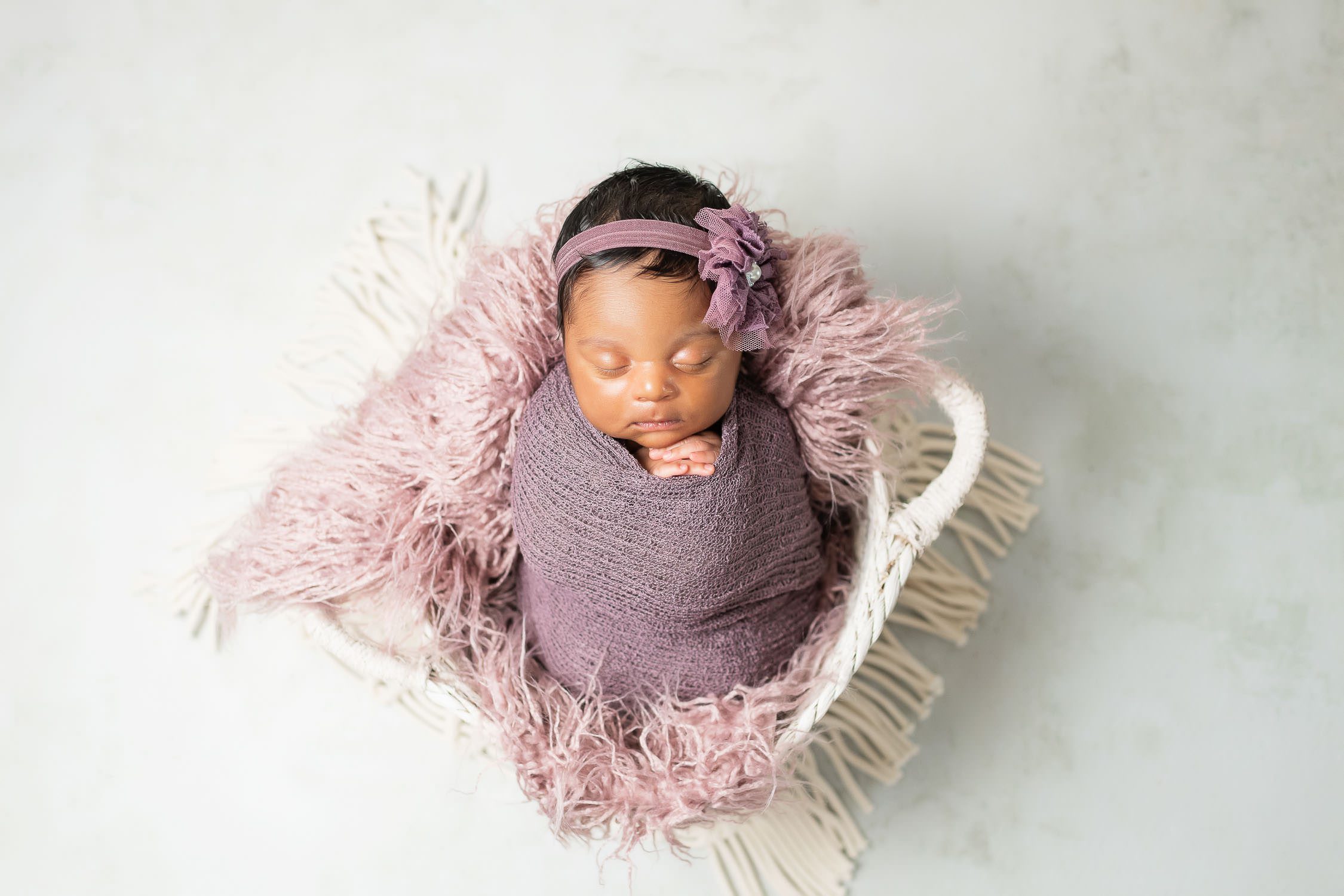 newborn baby sleeping in white basket-niccole photography