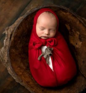 newborn wrapped like little red riding hood