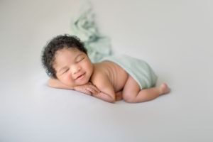 Newborn baby sleeping and smiling