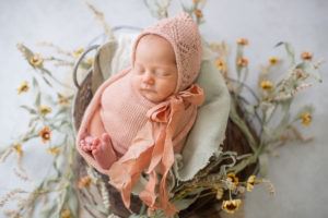 newborn baby in bucket with flowers_niccole photography