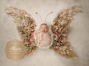 baby as a butterfly with wings of flowers niccole photography