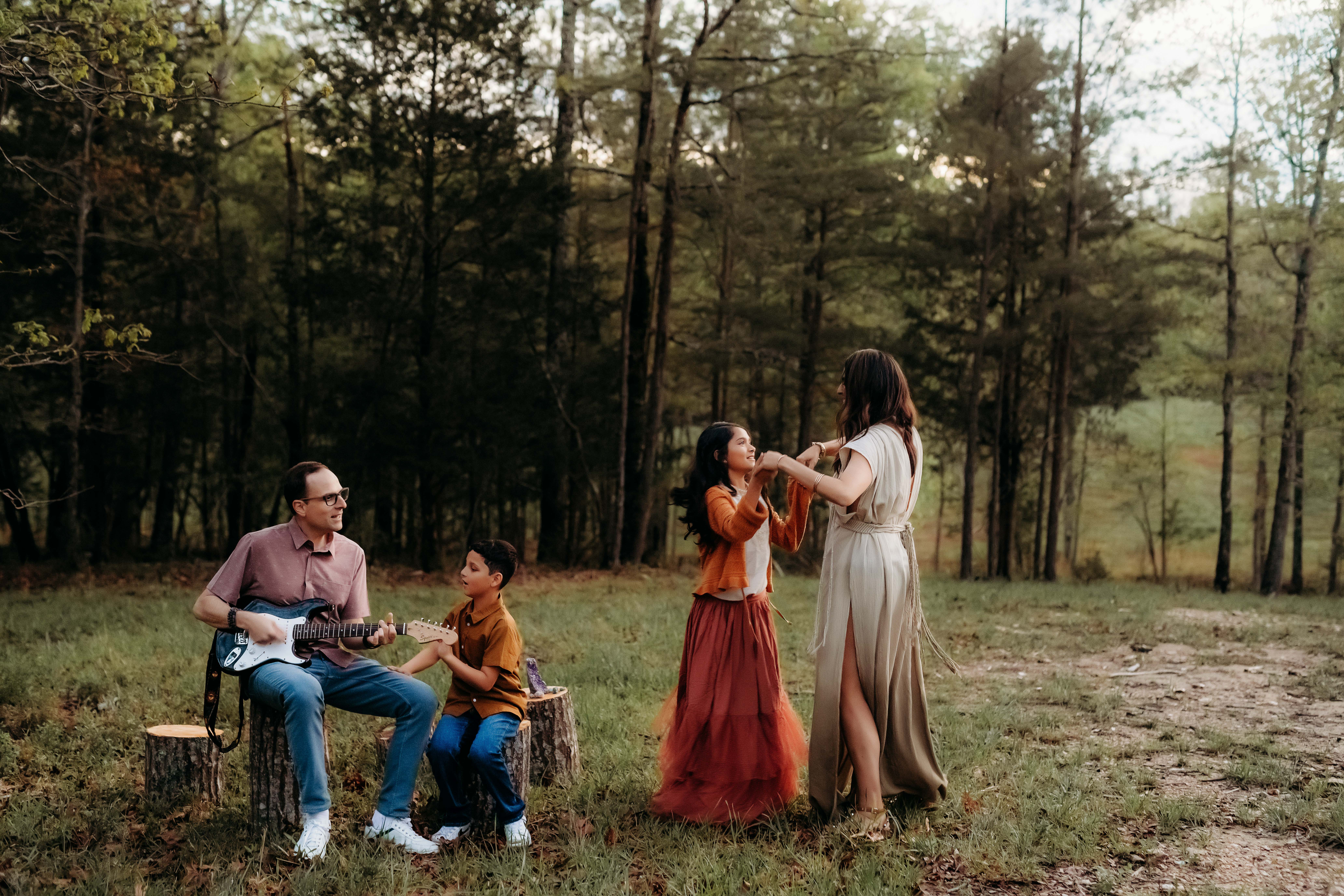 family dancing in field for family photoshoot