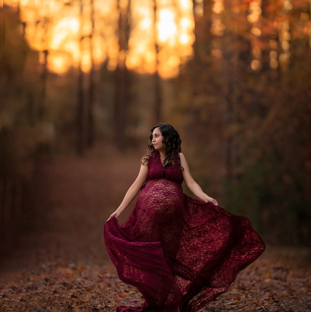 gorgeous pregnant mom swinging dress in woodsy location